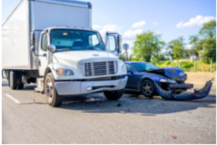 Collision of a semi truck with box trailer a passenger car on the highway road