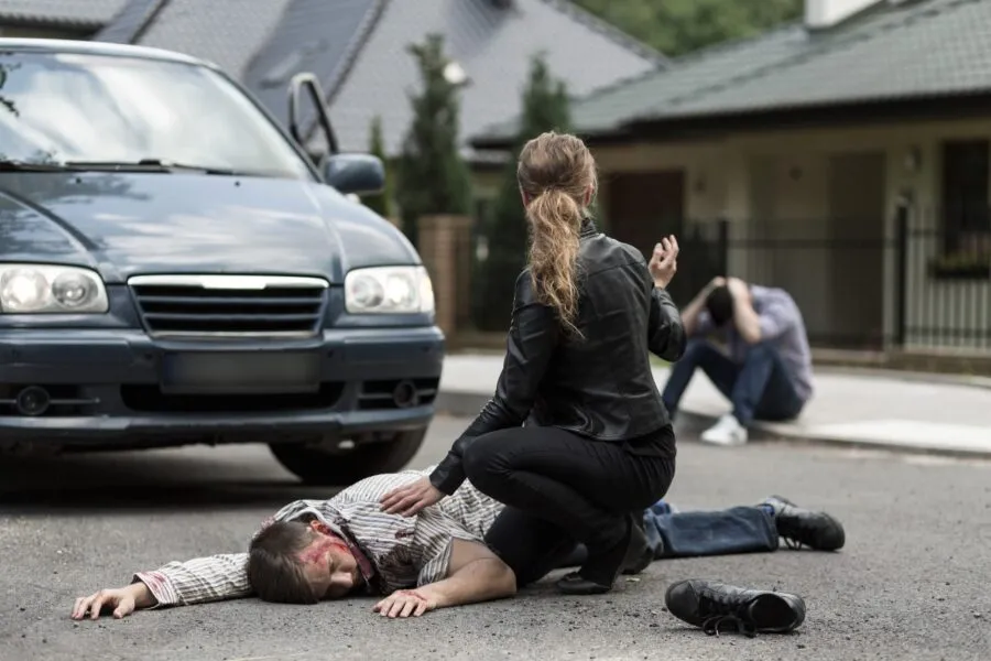Bloody victim of car accident lying on the street