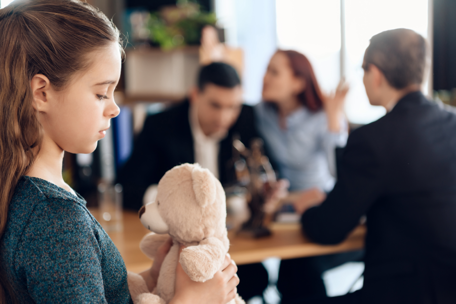Family in office of family lawyer. Two parents fighting over child in divorce concept.