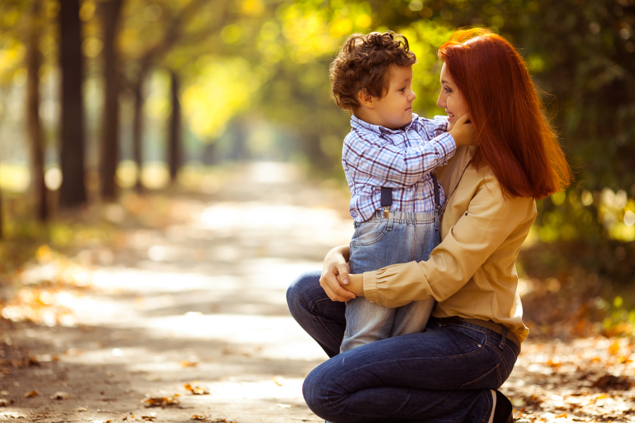 happy mother playing with her son in the park
