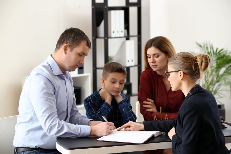 Divorced parents with their son visiting lawyer. Concept of child support