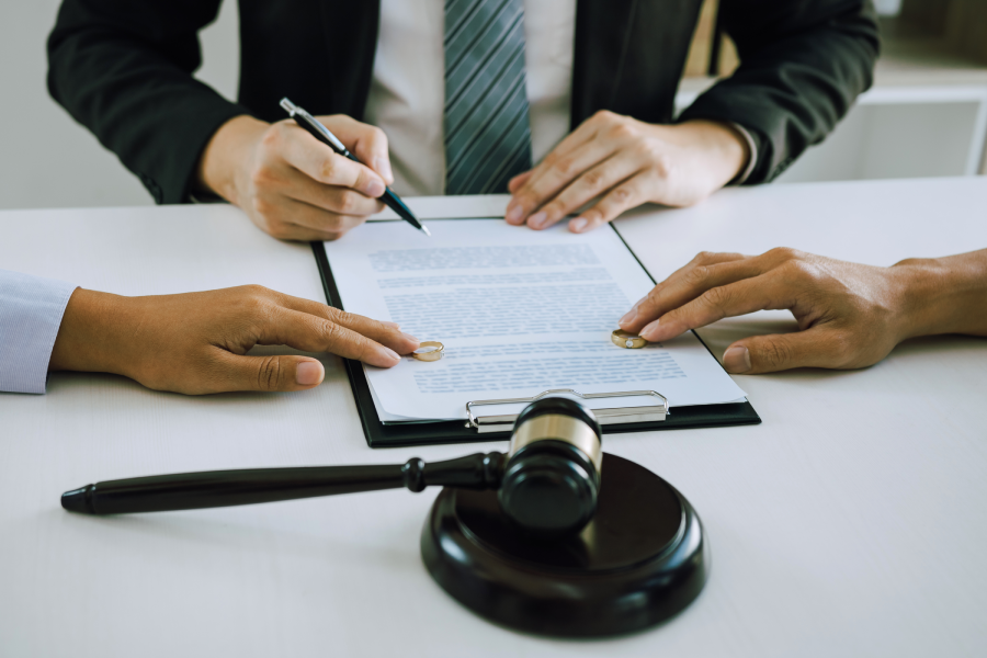 Couple is divorced who handed their engagement ring to the divorce documents that the lawyer was clarifying.