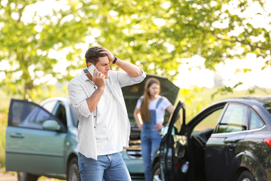 Man calling his insurance agent after car accident