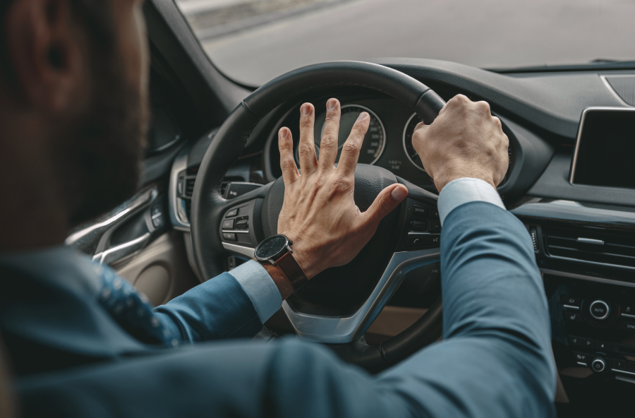 Unrecognized man in formal wear traveling by a car