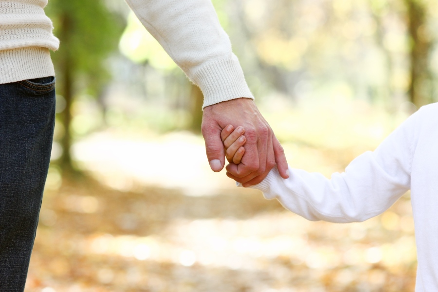 hands father holding child concept support family