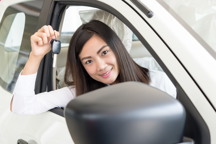 Young Happy Woman Showing The Key Of her New Car, Dream comes true concept